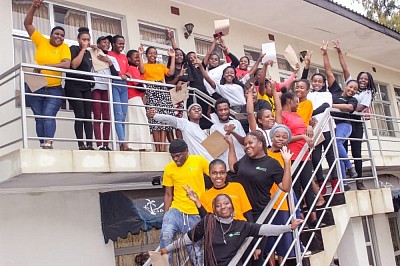 Youth taking a group photo after graduating from Monitoring and Evaluation Training course